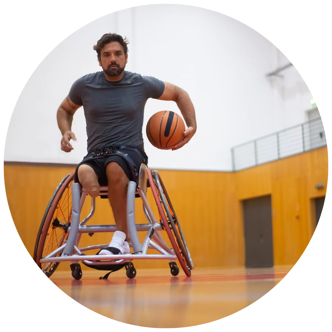 Disabled man on his wheelchair playing basketball