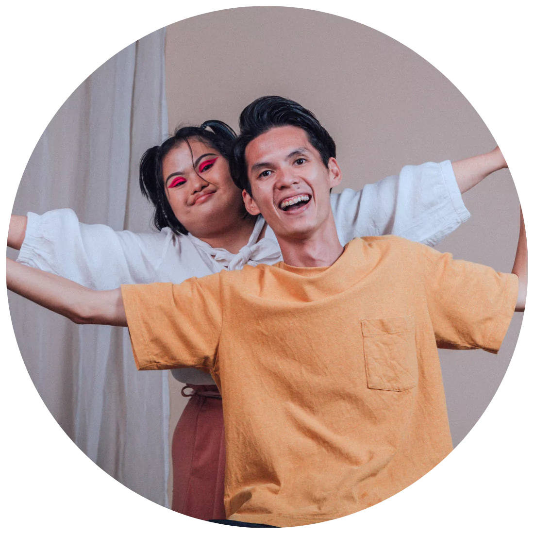 A disabled woman and her support worker happily smiling for a photo
